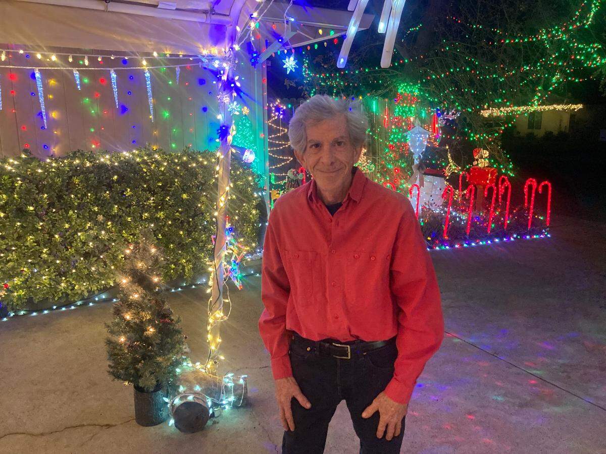 Tony Levy, 59, stands amidst his Christmas decorations on Dec. 4, 2024, at his home at 8985 Twin Falls Drive in Sacramento.