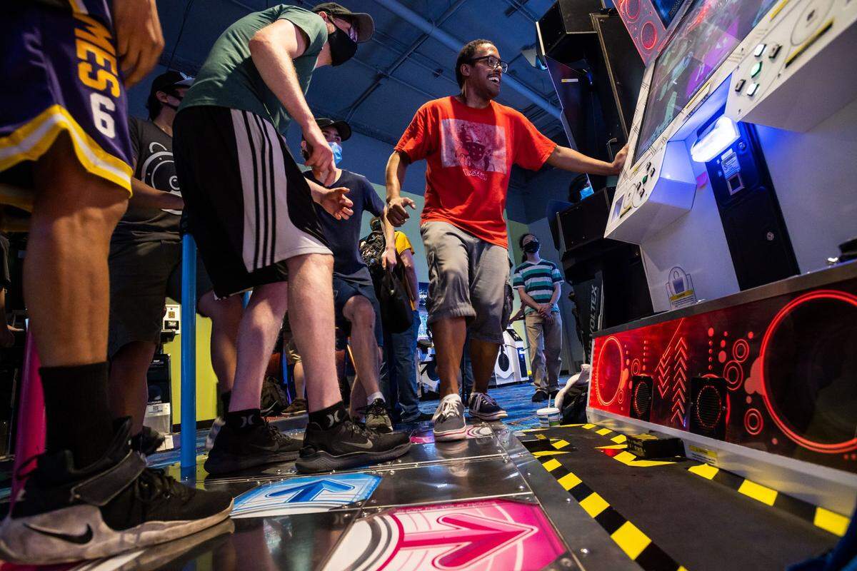 Cameron Oates, right, plays Dance Dance Revolution with a group of friends from Sacramento on Saturday, during Round1 Bowling & Amusement’s opening day at Westfield Galleria at Roseville. The multi-entertainment business from Japan which features hundreds of arcade games, bowling, billiards, food and more opened the Roseville location in space formerly occupied by Sears.
