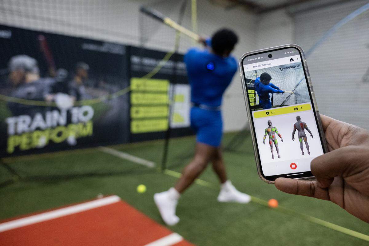 Athlete Miles Williams tests a product at Elk Grove-based sports tech company Core Impact last month that tracks muscle use. Founder Sam Taylor’s products caught the attention of MLB All-Star Mookie Betts, who is now an investor.