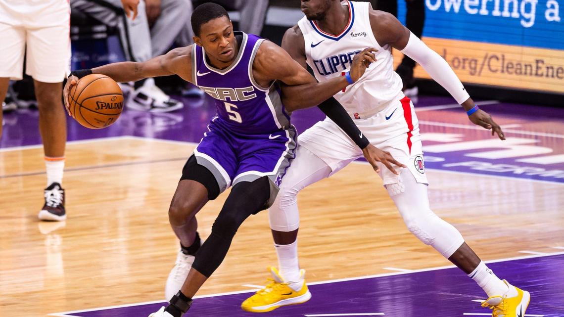 Sacramento Kings guard De’Aaron Fox (5), left, tries to fend off getting tangled by LA Clippers guard Reggie Jackson (1) during the second period of the NBA game Friday, Jan. 15, 2021, at Golden 1 Center in Sacramento.