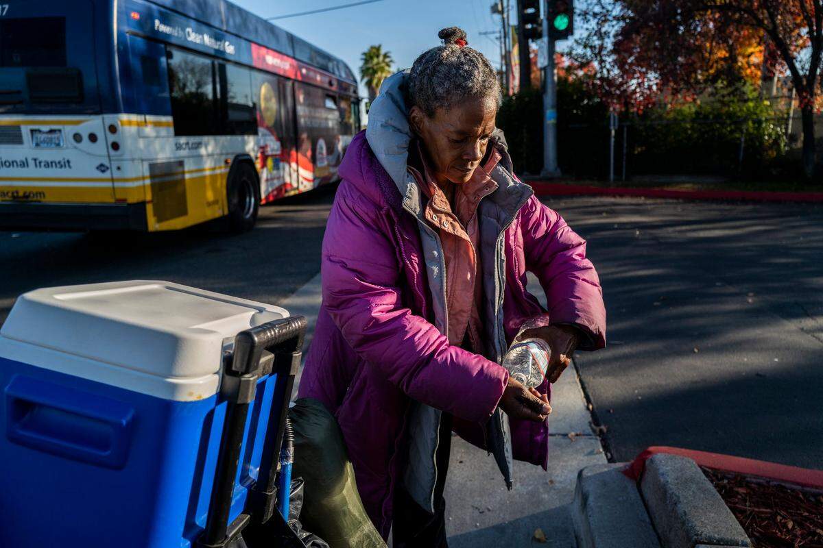 Sharon Pendarvis, washes her hands while waiting for a bus after leaving a storage facility where she sorted through her things for essentials to survive on the street After watching a tenant wash his dirty shoes in the kitchen sink at Sacramento Self-Help Housing where she lived, she said “It made it eerie for me to eat there.”