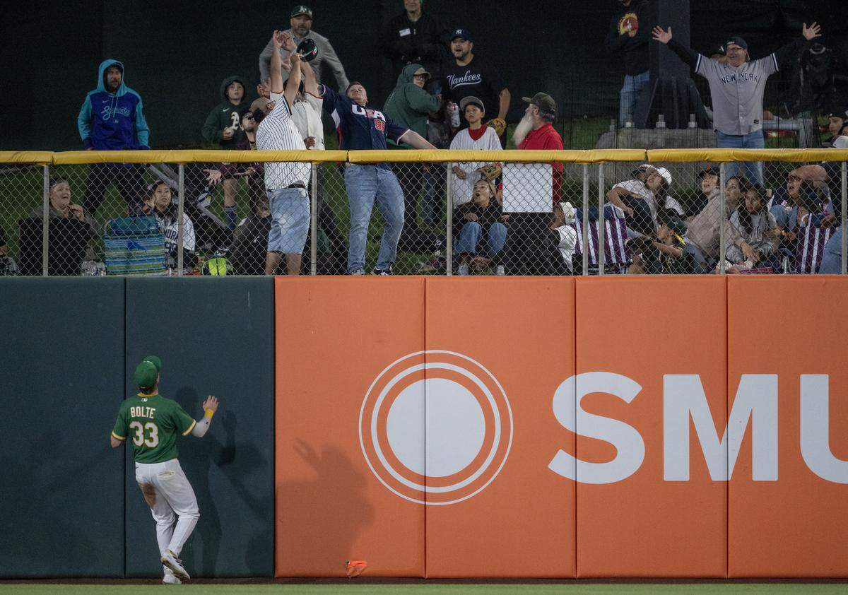 Athletics center fielder Henry Bolte watches the ball hit by New York Yankees first baseman Ben Rice land in the right center field grass for a home run on Friday at Sutter Health Park in West Sacramento.