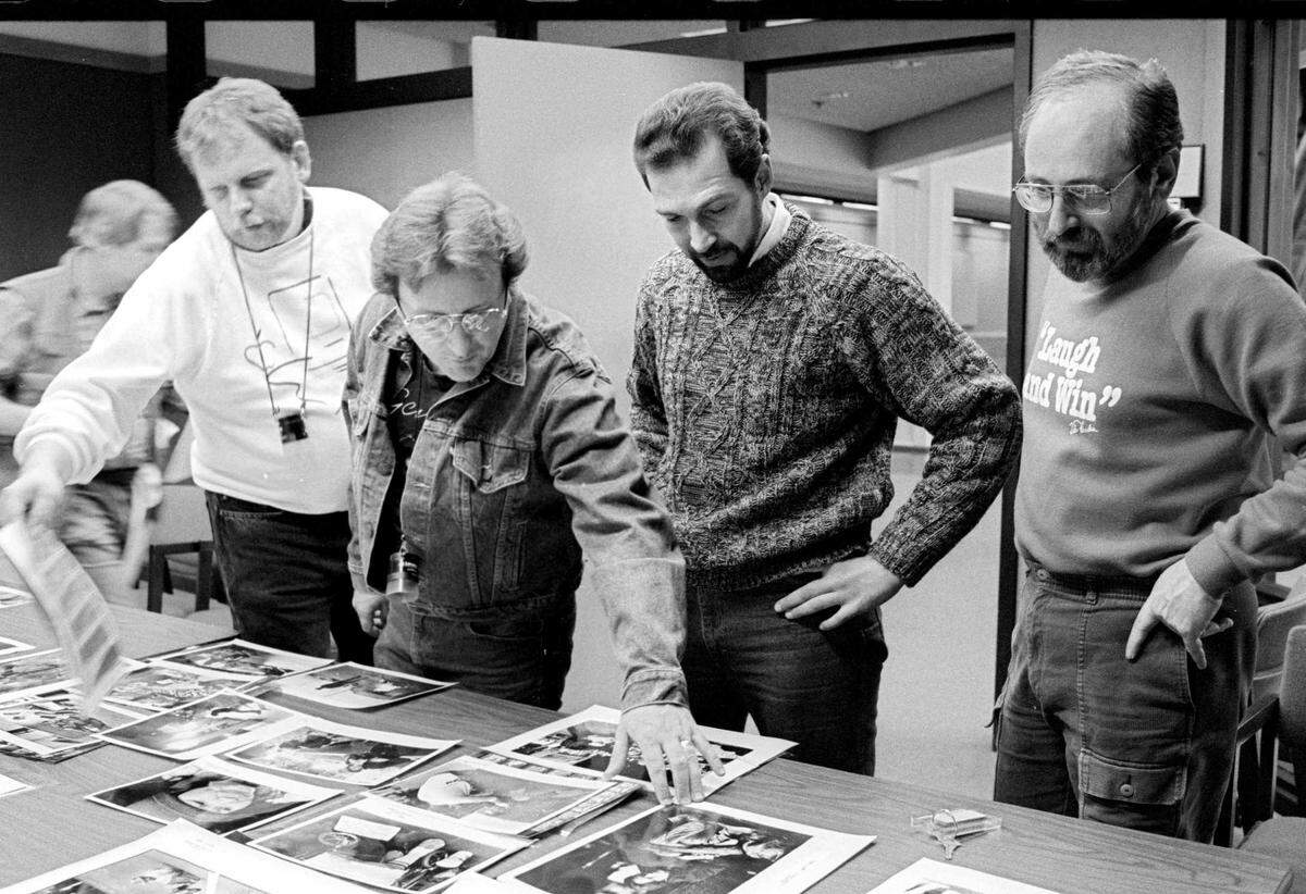 From left, George Wedding, The Bee’s director of photography; picture editor Rick Shaw; Ed Canale, an assistant managing editor for features and graphics; and Mort Saltzman edit photos for the March 1989 project “24 hours in the Life of the Homeless.” Saltzman, a witty and tough-minded editor and leader who had an instinct for breaking news, died Wednesday at the age of 82.