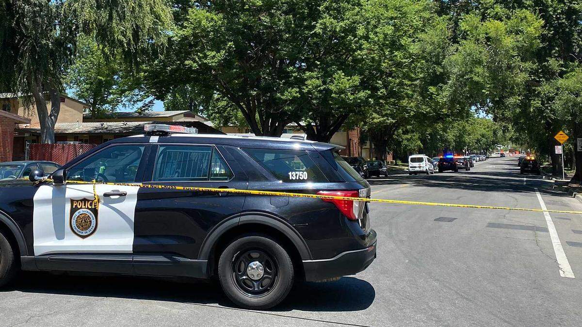 Police vehicles and tape block off Fifth Street at Vallejo Way in the Upper Land Park section of Sacramento following a shooting Sunday, June 23, 2024.