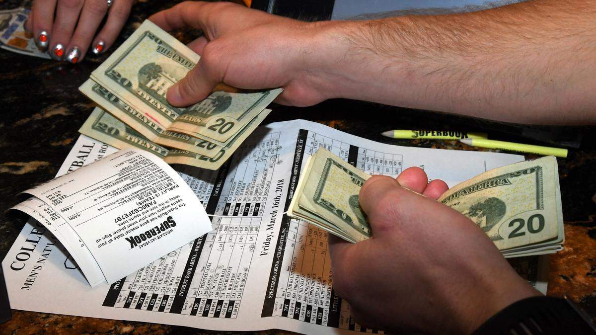 In this 2018 file photo, Jake Sindberg of Wisconsin makes bets during a viewing party for the NCAA Men’s College Basketball Tournament inside the Race & Sports SuperBook at the Westgate Las Vegas Resort & Casino in Las Vegas.