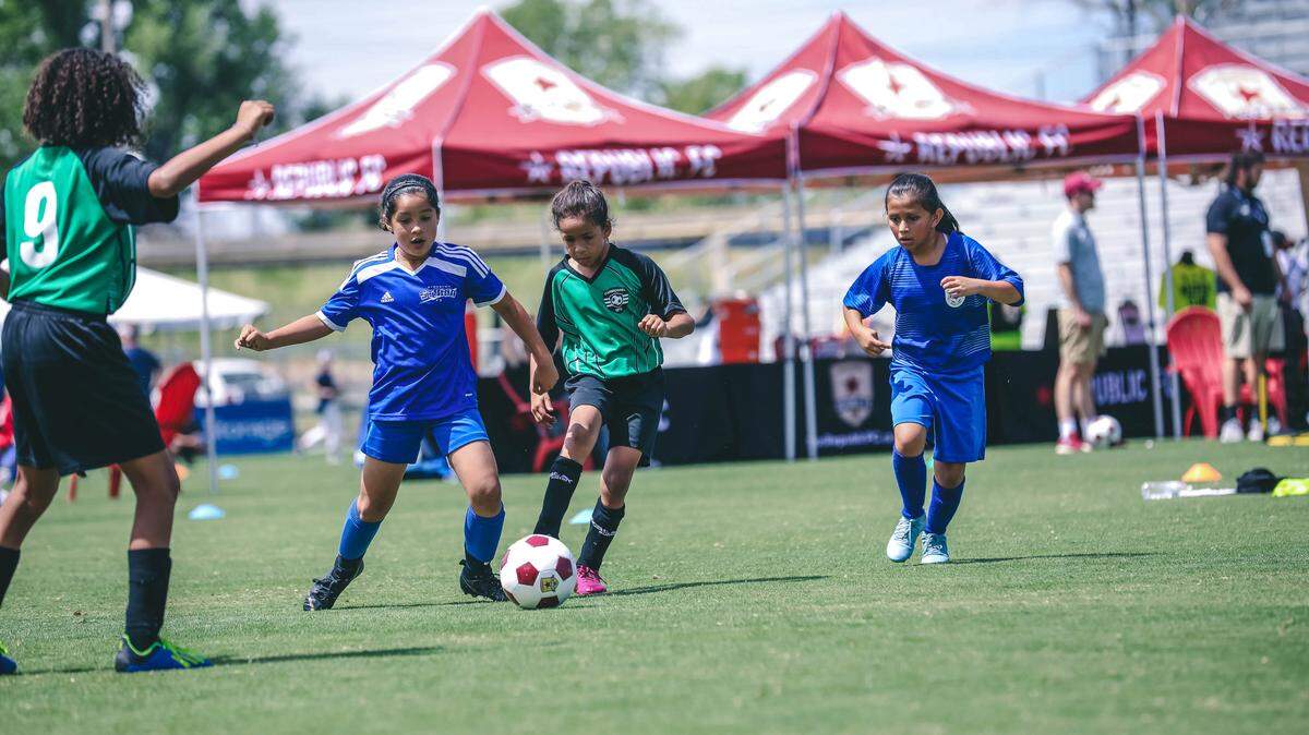Players dribble the ball at a Sacramento Republic FC all-girls soccer tournament to support female empowerment through the #WatchMe campaign.