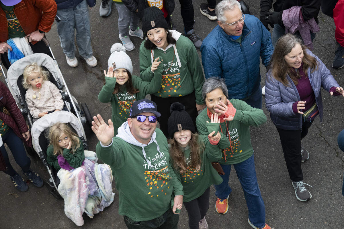 Race participants wave to the crowd during the Run to Feed the Hungry in Sacramento on Thursday, Nov. 27, 2025.