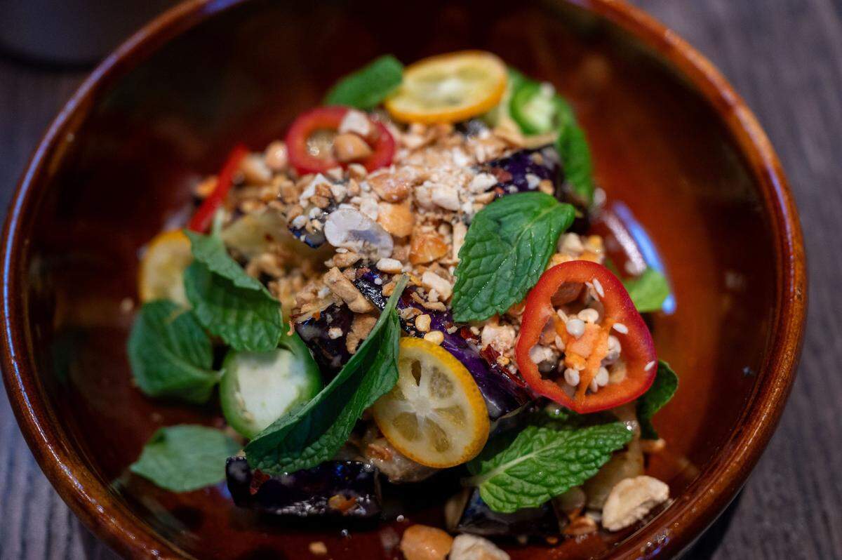 Chili eggplant is made with candied cashews, fresh and dried chilies, mint, dobanjiang and honey aioli at Chu Mai.
