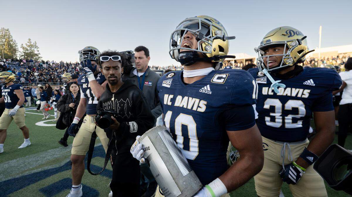 UC Davis Aggies defensive back Jayden Stanley (10) carries the Causeway Carriage trophy following the 31-27 victory over the Sacramento State Hornets in the Causeway Classic at UC Davis on Saturday.