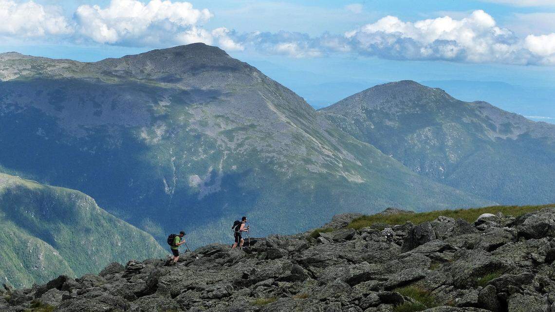 A pair of hikers scales Mount Washington in New Hampshire in 2016. A family that left an 80-year-old hiker behind Thursday on the mountain may be billed for his rescue later that night, officials say. He suffered hypothermia.
