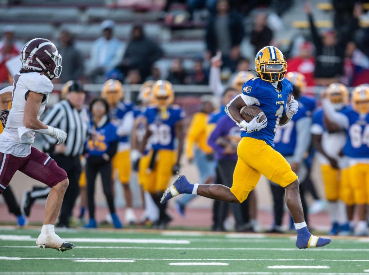 Grant Pacers running back Wayshawn Parker (1) scampers for a long touchdown in the second half of the CIF Sac-Joaquin Section Division III championship game against the Woodcreek Timberwolves on Friday at Hughes Stadium.