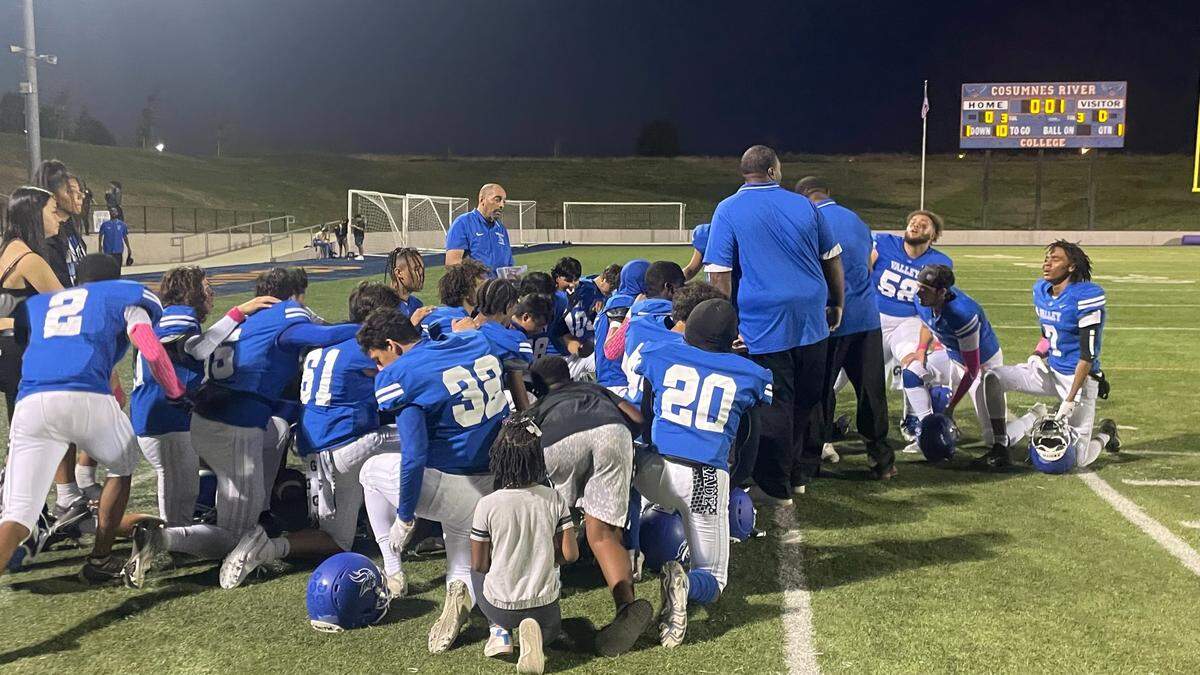 Valley High School football players kneel for a pregame prayer before their game against Cordova on Friday, Oct. 6, 2023, at Cosumnes River College. Low roster numbers have led to the cancellation of the varsity football seasons at Florin and Valley high schools of the Elk Grove Unified School District.