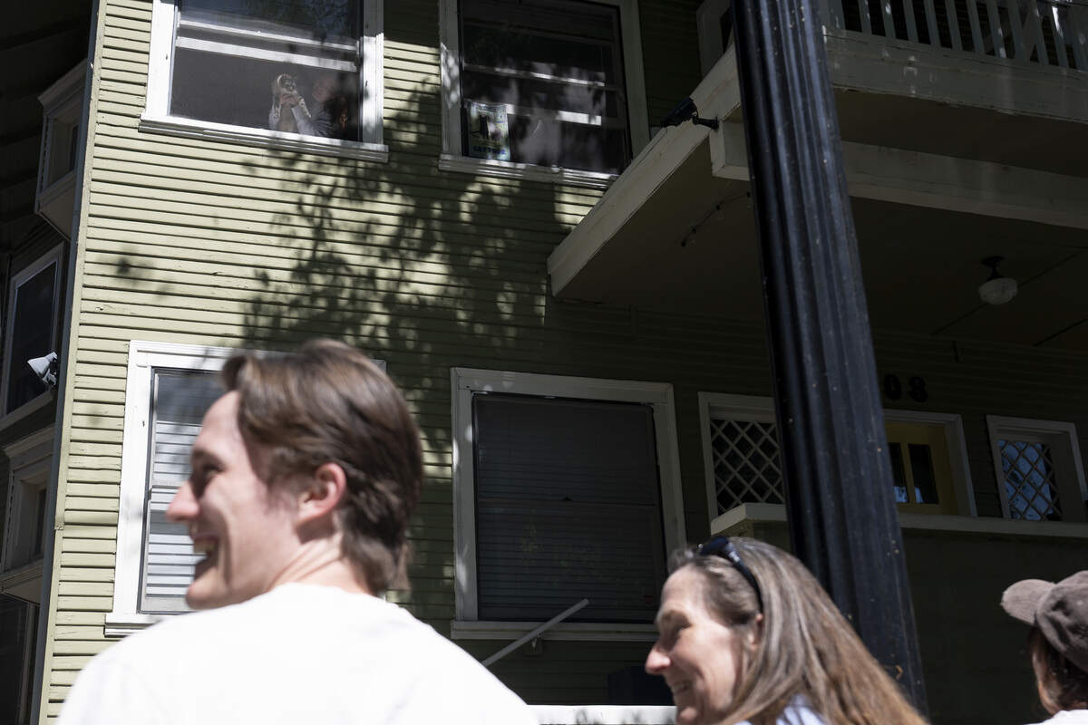 Torrey the cat is held up in the window of a house on 19th Street during the NorCal Resist Cat Tour in Sacramento on Sunday, June 7, 2026.