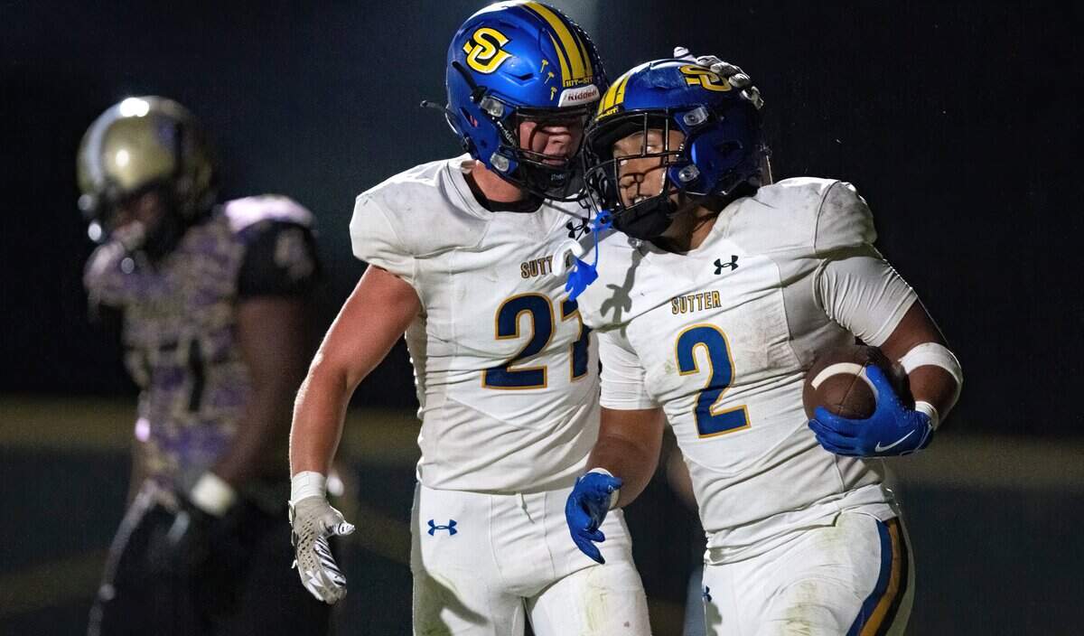 The Sutter Huskies' Losi Asiata (2) is congratulated by fellow running back Gary Bicknell (21) after a fourth quarter touchdown against the Bradshaw Christian Pride in Vineyard in September.