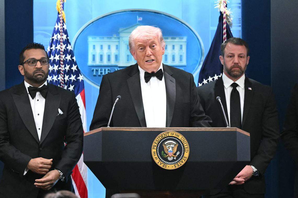 US President Donald Trump speaks, flanked by FBI Director Kash Patel and US Secretary of Homeland Security Markwayne Mullin, during a press briefing in the Brady Briefing Room at the White House in Washington, DC, shortly after a shooting incident at the White House Correspondents' Dinner on April 25, 2026. US President Donald Trump said April 25 he would give a press conference from the White House press briefing room, shortly after a shooting incident at a gala dinner in Washington. The press conference is set to take place shortly after 10 p.m. (0200 GMT), Trump wrote on his Truth Social platform, adding: "The First Lady, plus the Vice President, and all Cabinet members, are in perfect condition." (Photo by Mandel NGAN / AFP via Getty Images)
