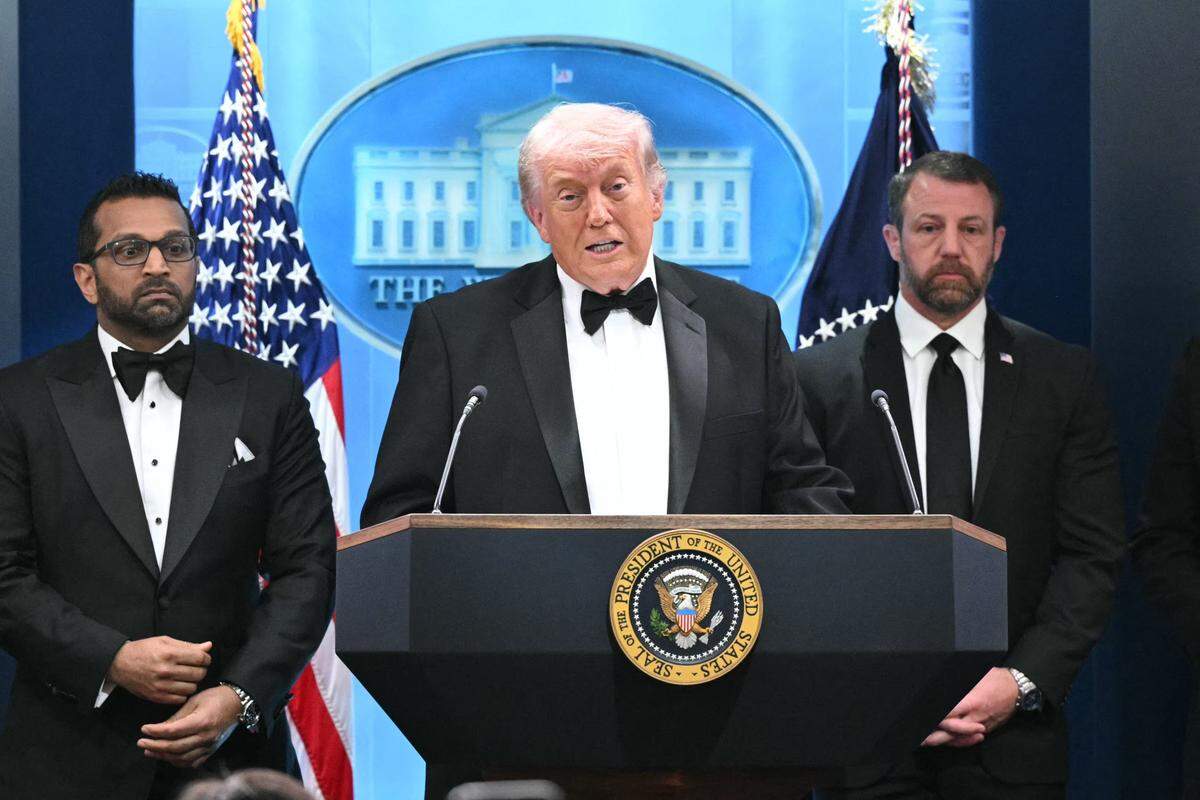 US President Donald Trump speaks, flanked by FBI Director Kash Patel and US Secretary of Homeland Security Markwayne Mullin, during a press briefing in the Brady Briefing Room at the White House in Washington, DC, shortly after a shooting incident at the White House Correspondents' Dinner on April 25, 2026. US President Donald Trump said April 25 he would give a press conference from the White House press briefing room, shortly after a shooting incident at a gala dinner in Washington. The press conference is set to take place shortly after 10 p.m. (0200 GMT), Trump wrote on his Truth Social platform, adding: "The First Lady, plus the Vice President, and all Cabinet members, are in perfect condition." (Photo by Mandel NGAN / AFP via Getty Images)