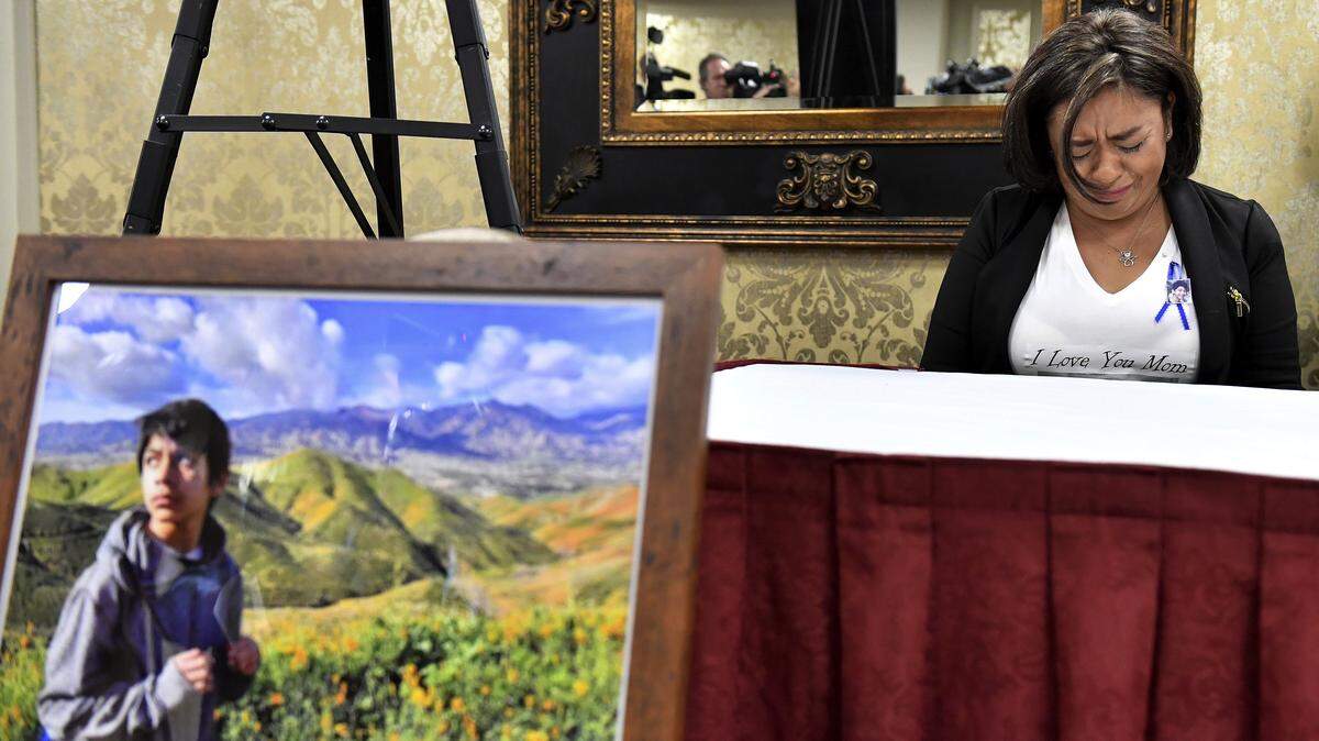 Juana Salcedo, aunt and guardian of 13-year-old Diego Stolz, cries during a news conference in Riverside, Calif., Tuesday, Oct. 29, 2019, announcing the family has started legal proceedings against the Moreno Valley Unified School District. The family of Stolz says he complained to an administrator that he was being bullied at his Southern California middle school days before the assault that killed him. (Will Lester/The Orange County Register via AP)