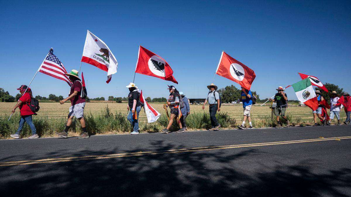 Supporters and members of the United Farm Workers union march in Galt on Tuesday on their way to Sacramento to ask for Gov. Gavin Newsom’s signature on AB 2183. The bill would let farm workers vote by mail to unionize. The 24-day, 335-mile march concludes Friday with a rally at the west steps of the Capitol.