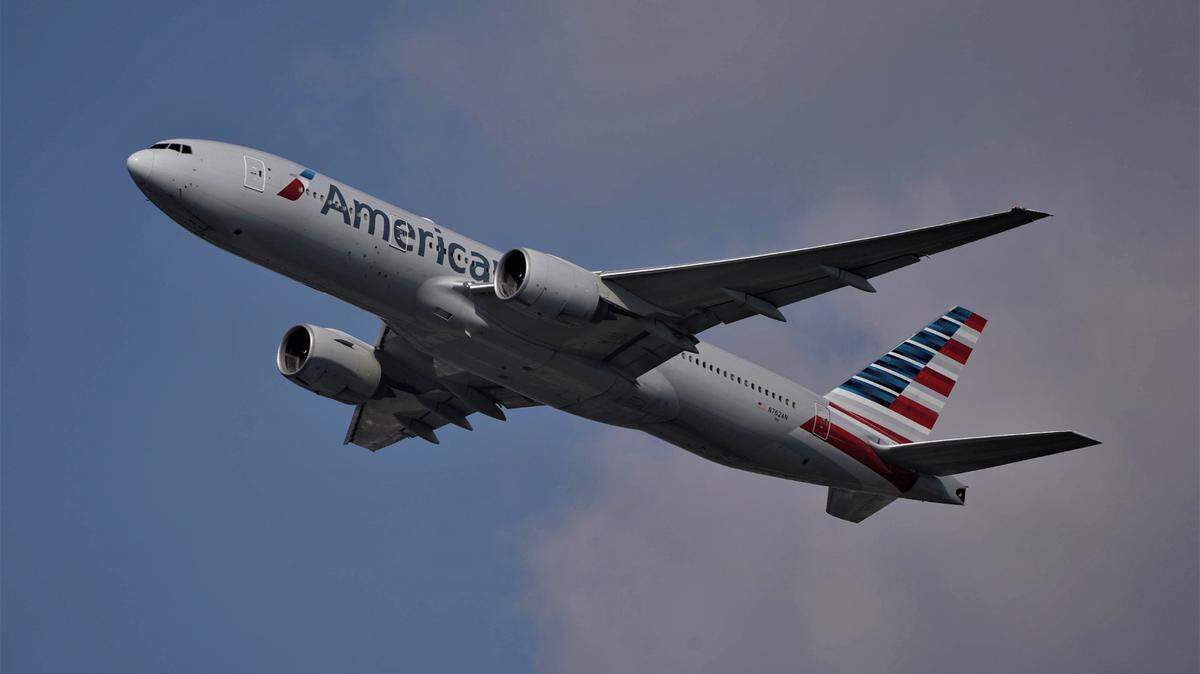 A woman threatened an American Airlines flight crew and passengers over wearing a face mask, feds say.