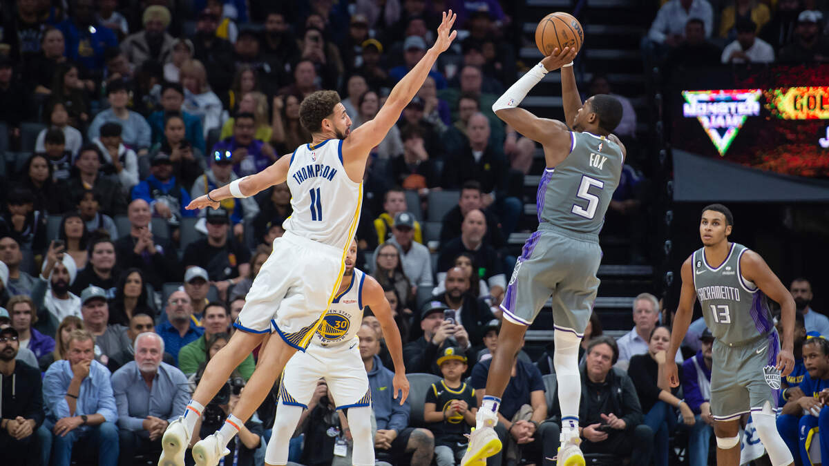 Sacramento Kings guard De’Aaron Fox (5) shoots over Golden State Warriors guard Klay Thompson (11) during the fourth quarter in the NBA basketball game Sunday, Nov. 13, 2022, at Golden 1 Center in Sacramento. Fox had 22 points and eight assists. The Kings won 122-115.