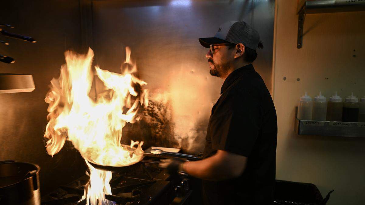 Wok stir-fried beef tenderloin is prepared by chef-owner Giancarlo Zapata for the dish lomo saltado a La Antigua at Chicha Peruvian Bistro in Sacramento earlier this month. 