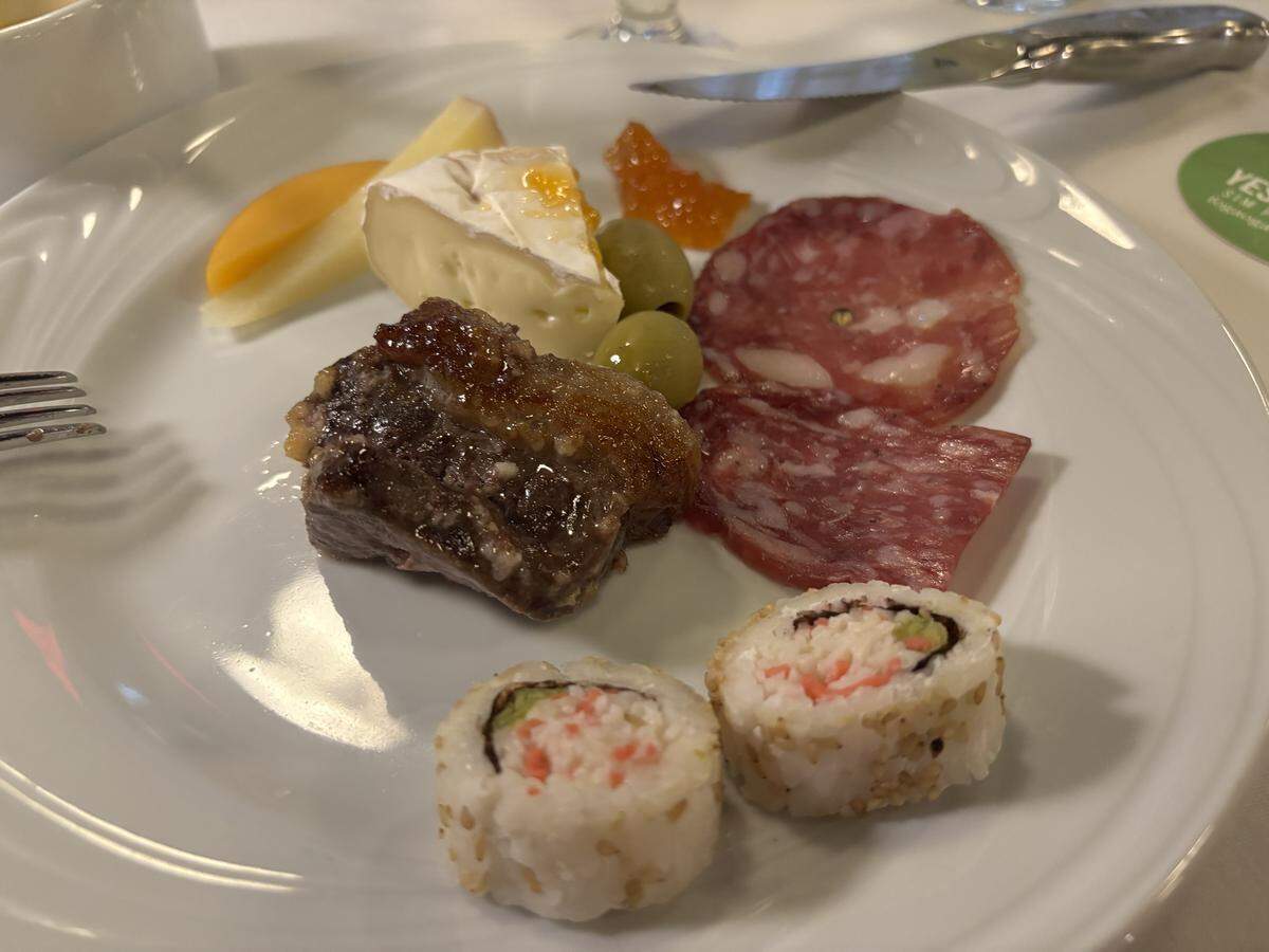 A freshly sliced cube of garlic beef at Fogão Gaúcho Brazilian Steakhouse in Elk Grove is accompanied by side dishes from the restaurant’s Market Table buffet, including pieces of sushi and charcuterie meats and cheeses.