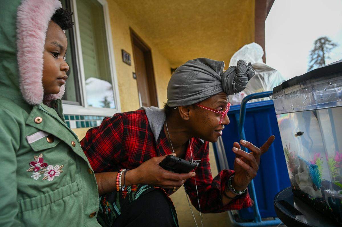 Tanika Williams, 38, arrives on Feb. 15 with daughter Makhila Williams, almost 3, to see if their beloved betta fish Bluez was alive after property managers had left the fish tank outside overnight at The Greens Hotel, a city-run homeless shelter. They had owned the fish over a year and had kept it as they searched for housing.