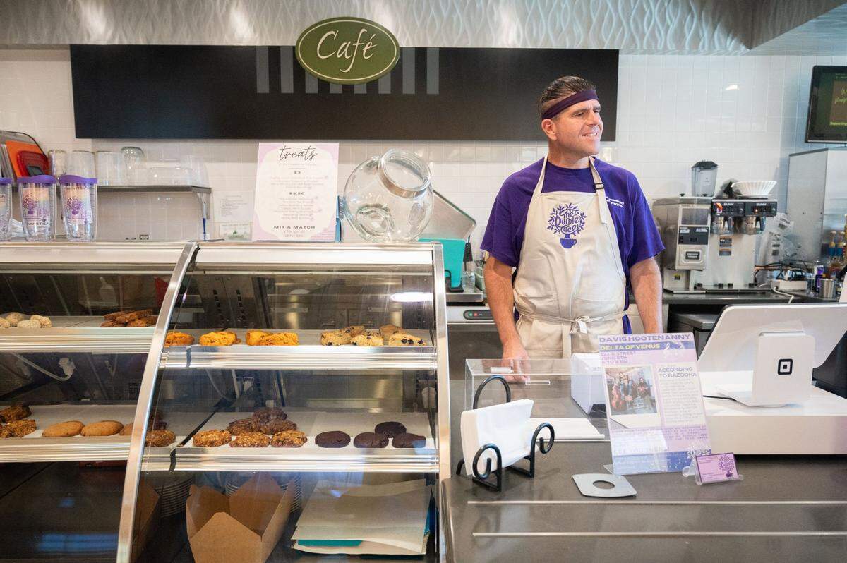 Purple Tree Café employee Tone Martinez thanks a customer earlier this month at the cafe, which is housed inside the MIND Institute at the UC Davis Medical Center in Sacramento. Martinez is a person with autism. He said he struggles with social anxiety and can get overwhelmed easily, so he appreciates the flexibility and support the cafe and his fellow staff members provide.