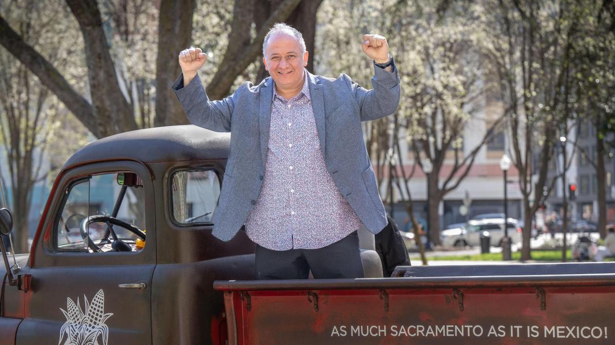 Ernesto Delgado, owner of La Cosecha and three other restaurants in the Sacramento area, stands on a vintage truck at his restaurant in Cesar Chavez Plaza on Thursday. Delgado will soon be adding a ceviche restaurant across the street.