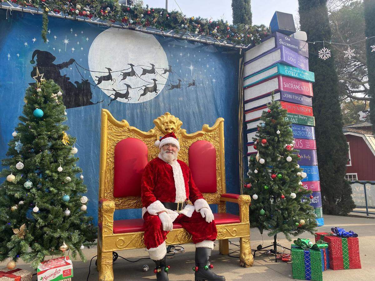 Santa Claus poses for a photo on the Mother Goose stage at the Fairytale Town Winter Wonderland event in Sacramento’s William Land Regional Park in 2024.