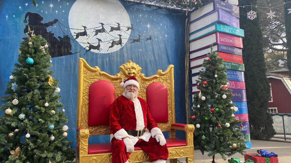 Santa Claus poses for a photo on the Mother Goose stage at the Fairytale Town Winter Wonderland event in Sacramento’s William Land Regional Park on Saturday. The event continues Sunday and Dec. 14-15.