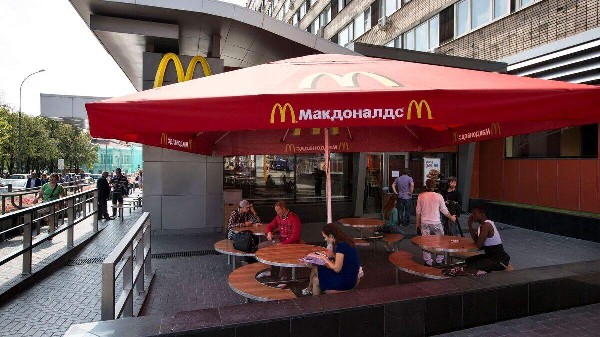 People walk past the oldest Moscow McDonald’s in 2014. (AP Photo/Alexander Zemlianichenko)