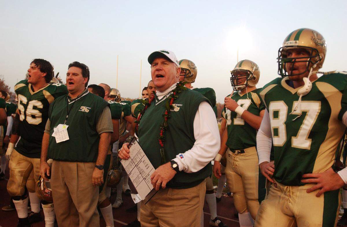 Hornets coach John Volek sings the Sacramento State fight song with his team following his team’s 42-35 victory over Humbolt State in 2002 at Hornet Stadium in Sacramento.