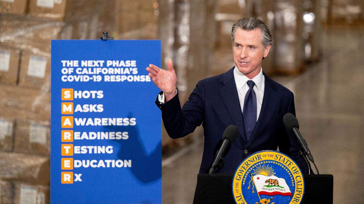 Gov. Gavin Newsom announces the next phase of California’s COVID-19 response called “SMARTER,” during a press conference at the UPS Healthcare warehouse in Fontana on Thursday, Feb. 17, 2022. The governor’s announcement marked the state’s shift to an “endemic” approach to the coronavirus pandemic that emphasizes prevention and quick reactions to outbreaks over mandates.