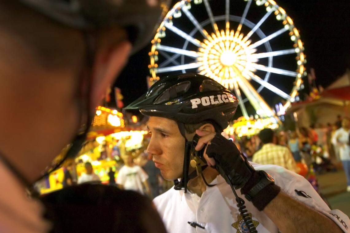 Cal Expo police officer Sam Sanchez listens to a call regarding a disturbance while patroling the State Fair on his bike in 2006. It’s the only fairgrounds in the nation with a full-time, year-round police force.