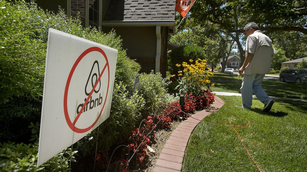 An anti-Airbnb sign is displayed in the yard of an East Sacramento home in 2018. Sacramento is considering a ban on short-term rentals in properties where the owner does not live, aiming to reduce neighborhood disturbances and boost long-term housing availability.