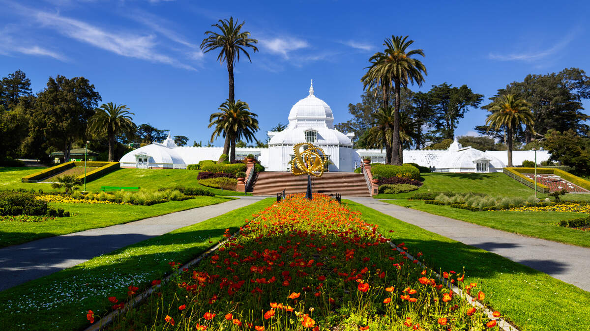 Golden Gate Park in San Francisco on a weekend, with the Conservatory of Flowers and flower beds.