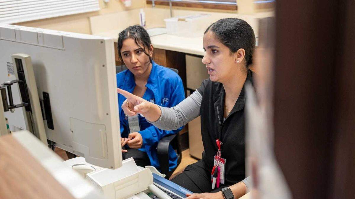 Licensed vocational nurse Jasman Gill, right, works with student vocational nurse Karissa Mena in the medical surgical unit at Glenn Medical Center in Willows on June 13, 2025. California’s health care system is overloaded with costs and does not need new legislative mandates this year.