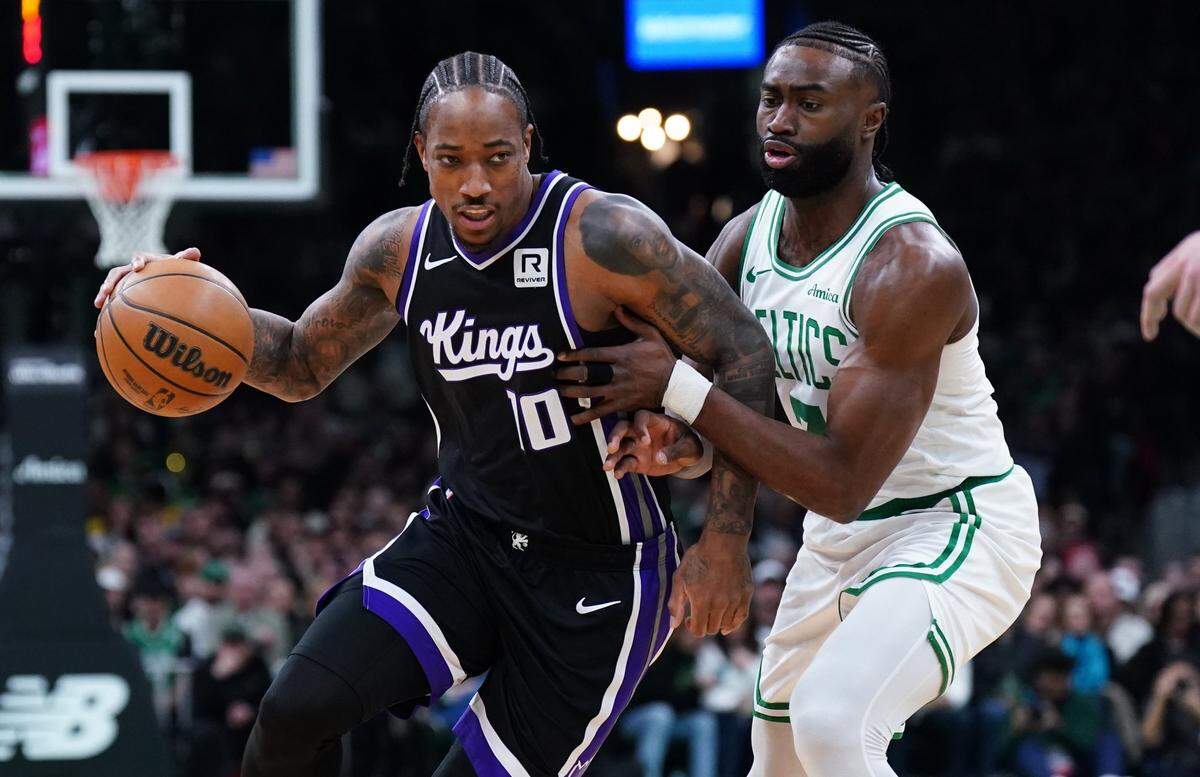Jan 10, 2025; Boston, Massachusetts, USA; Sacramento Kings forward DeMar DeRozan (10) drives the ball against Boston Celtics guard Jaylen Brown (7) in the first quarter at TD Garden. Mandatory Credit: David Butler II-Imagn Images