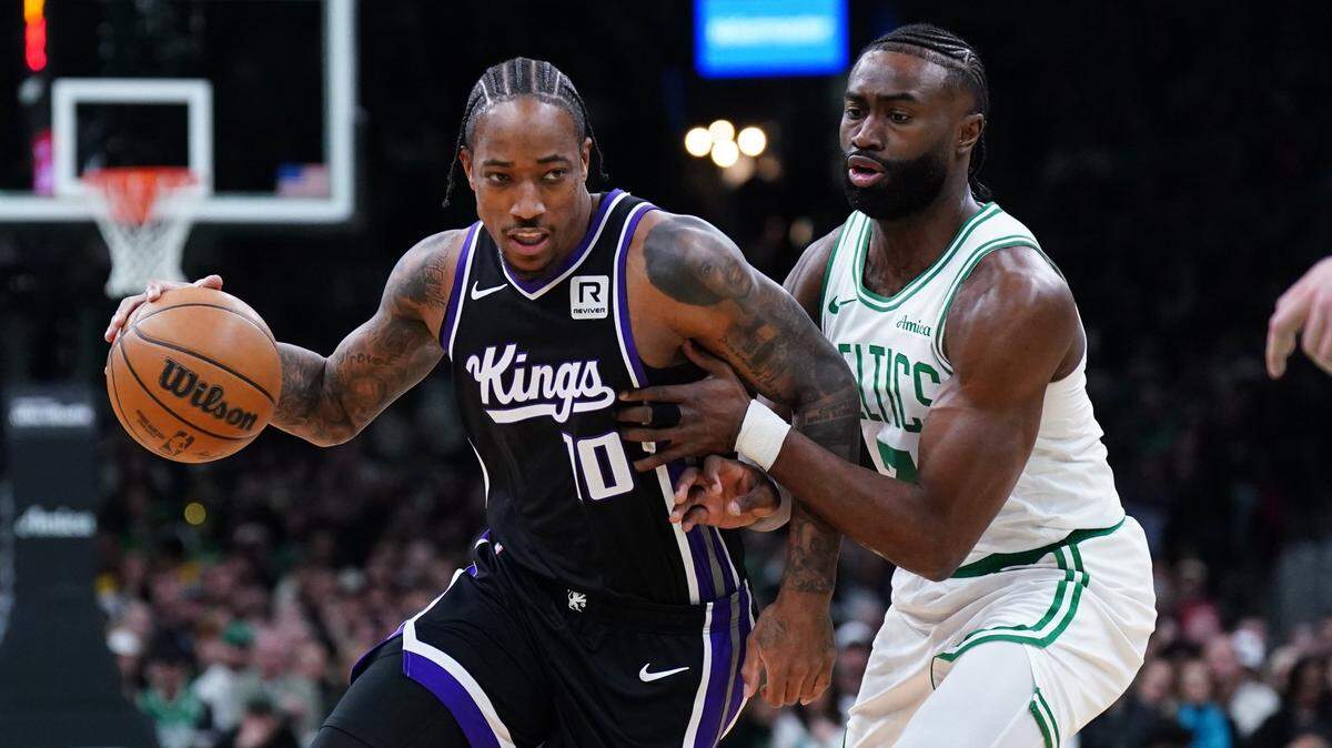 Jan 10, 2025; Boston, Massachusetts, USA; Sacramento Kings forward DeMar DeRozan (10) drives the ball against Boston Celtics guard Jaylen Brown (7) in the first quarter at TD Garden. Mandatory Credit: David Butler II-Imagn Images