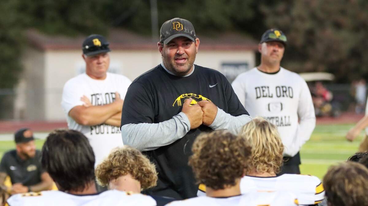 Del Oro High School football coach Mike Maben addresses his team after the annual Black & Gold Scrimmage.