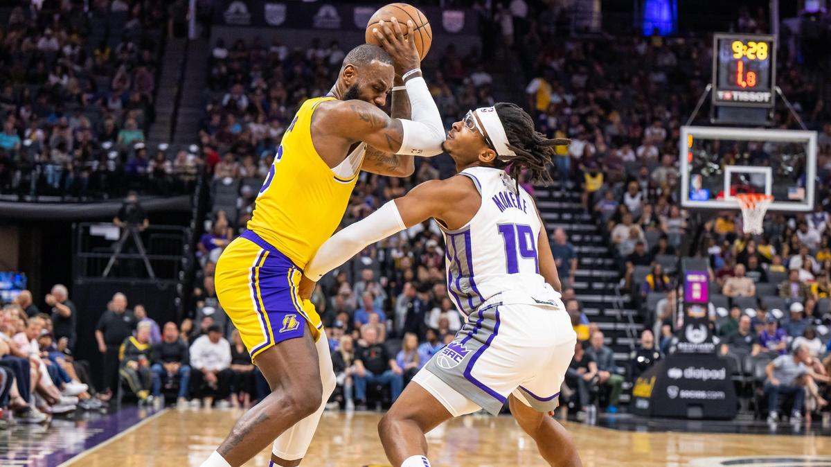 Sacramento Kings forward Chima Moneke (19), right, and Los Angeles Lakers forward LeBron James (6) get physical on a Lakers possession during the first half of the preseason NBA basketball game Friday, Oct. 14, 2022, at Golden 1 Center in Sacramento.