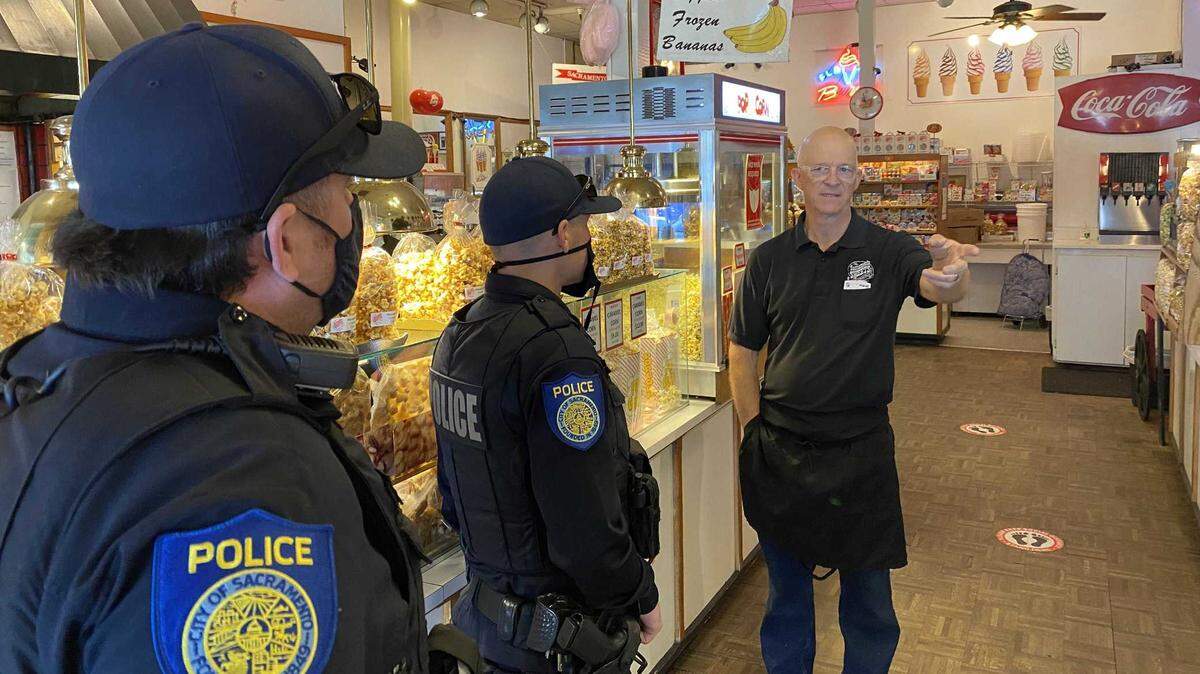 Jason Minow, owner of The Sacramento Sweets Co. candy store in Old Sacramento, speaks on Oct. 19 to police officers about proposed security upgrades to help prevent violence and crime in the area. The Sacramento City Council on Tuesday approved the first contracts to improve safety in Old Sacramento.