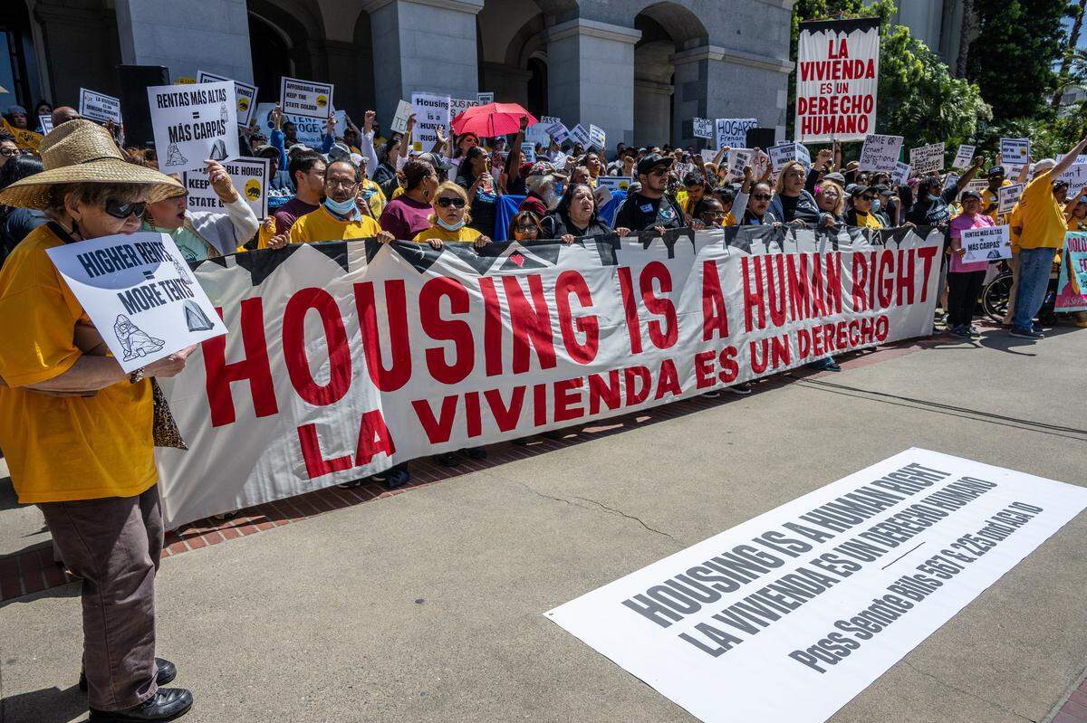 Protesters carry a banner saying “housing is a human right” as they participate in rally Monday, April 24, 2023, at the state Capitol in support of Assembly Constitutional Amendment 10, introduced Assemblyman Matt Haney, D-San Francisco, which would add housing to the rights enumerated in the California Constitution.