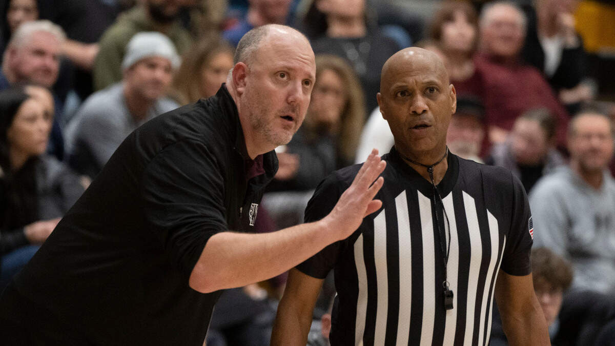Whitney head coach Nick French talks with a referee during a game at Del Oro High School in Loomis on Tuesday, Feb. 2, 2024. French's Whitney boys basketball team defeated Rio Americano in overtime Wednesday to advance in the CIF Sac-Joaquin Section Division II playoffs.