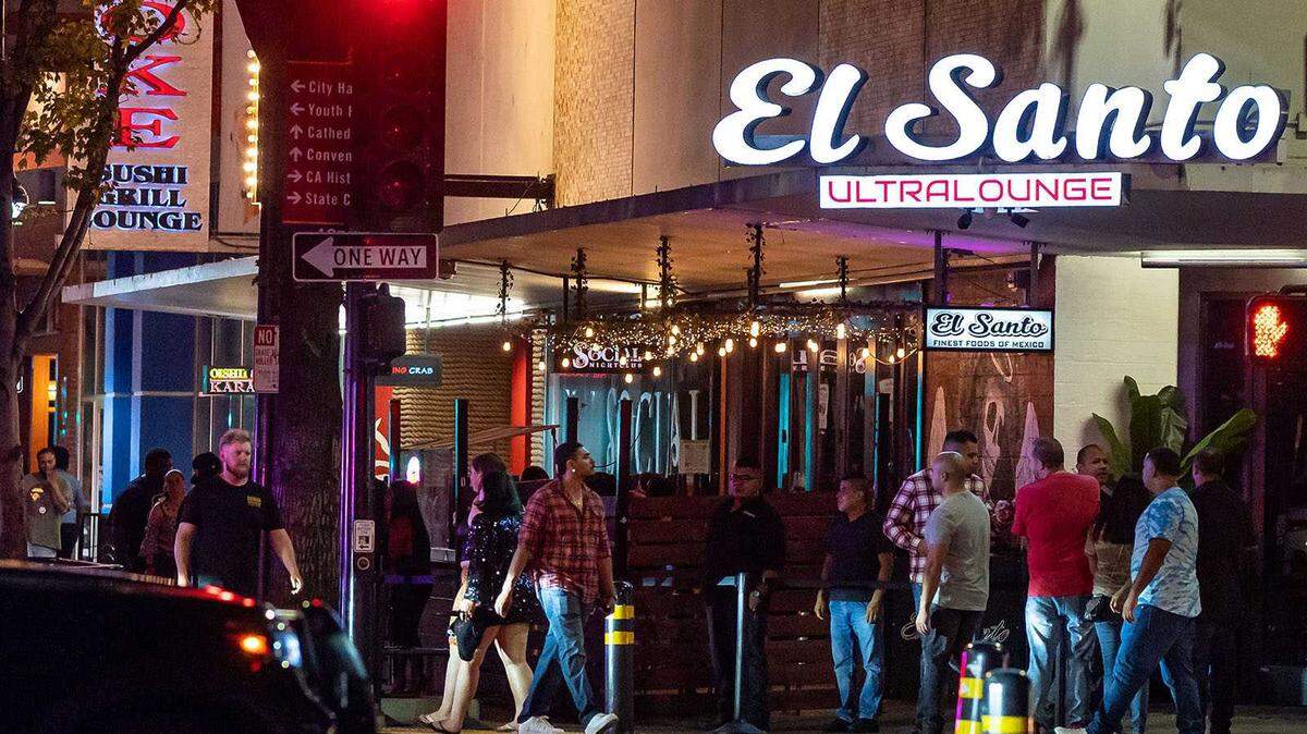 People walk around outside El Santo Ultra Lounge at the corner of K and 10th streets Sept. 3, as bars and nightclubs prepare to close for the night in downtown Sacramento. The Mexican restaurant and bar is the third restaurant to close in that location in the last five years.