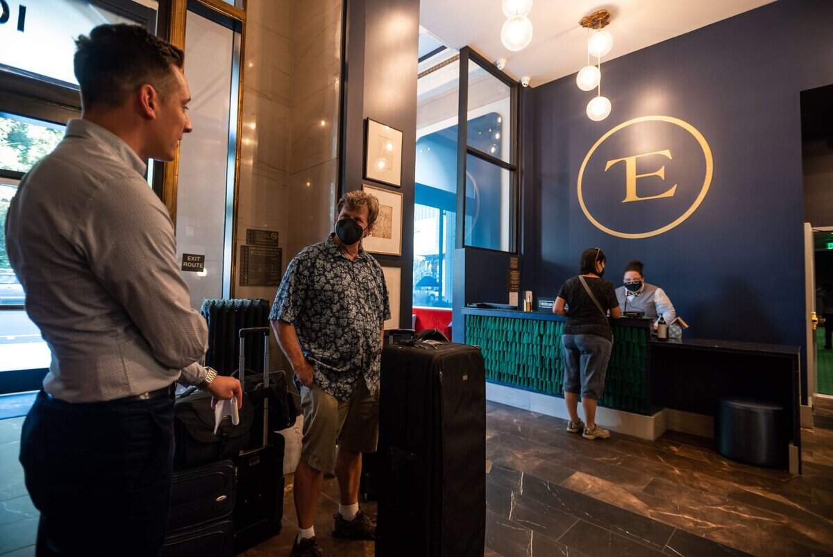 The Exchange Sacramento guest David Huff, center, of Phoenix, talks with Tyler DeWittie, director of sales and marketing at the boutique hotel, while checking in earlier this month.
