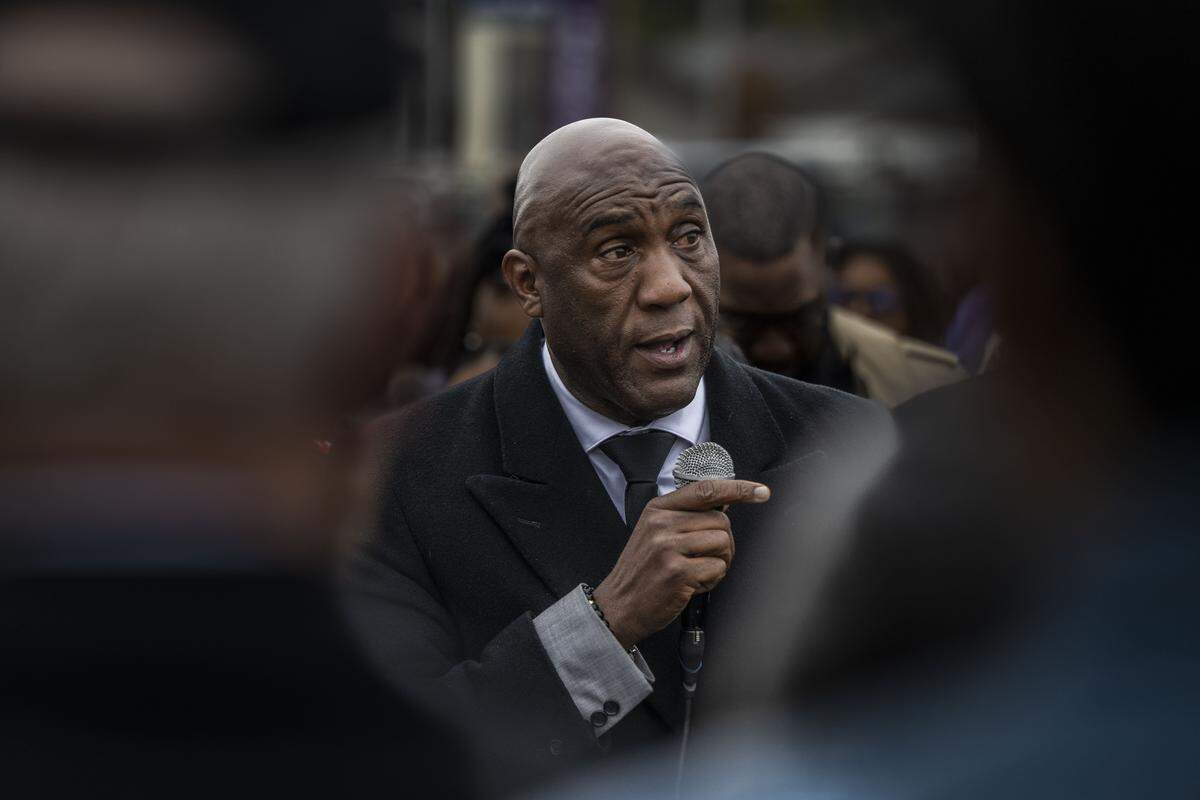Former Advance Peace director Nuri Muhammad speaks to community members at a vigil near Stockton on Nov. 30, the day after a mass shooting on the 1900 block of Lucile Ave. For Muhammad, the violence is personal as his own son Yusef was gunned down in 2023.