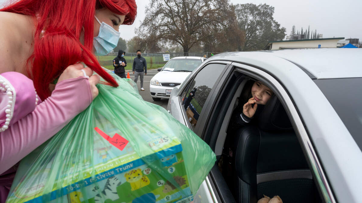 Brady Saetern, 2, waves at Ariel as she places toys in the car at the Yolo County Children’s Alliance 2021 Annual Holiday Toy Distribution on Saturday, Dec. 18, 2021 in West Sacramento. The Yolo County Children’s Alliance is one of 10 community organizations featured in this year’s Sacramento Bee Book of Dreams, its 34th year highlighting individual and organizational needs.