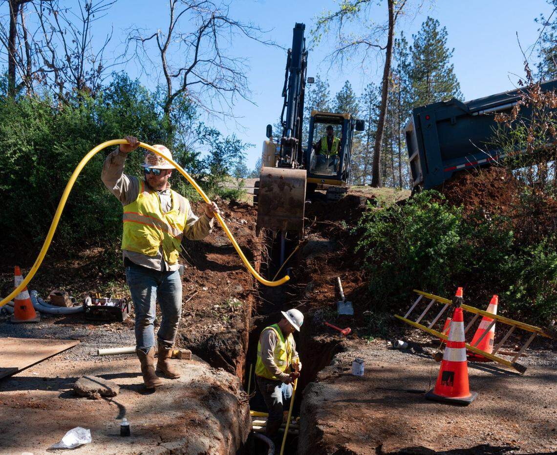 A PG&E crew buries power lines to homes on Travis Road in Paradise in Febuary. In some spots, PG&E’s crews are also replacing gas lines in an effort to reduce wildfire hazards. The Camp Fire, caused by one of the utility’s power transmission lines, killed 85 area residents in 2018.